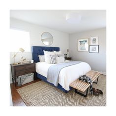 a bedroom with a bed, dresser and pictures on the wall above it is shown