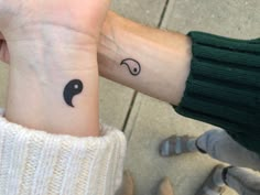 two people with matching tattoos on their wrist