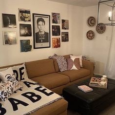 a living room filled with lots of furniture and pictures on the wall above it's couch