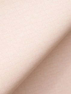 a close up view of a pink wallpaper with small squares on it's surface