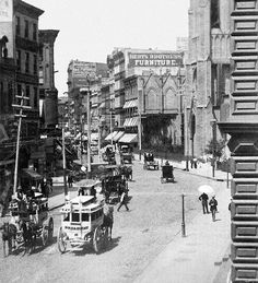 an old black and white photo of horse drawn carriages on a city street in the early 1900's