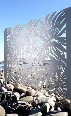 a white sculpture sitting on top of a pile of rocks