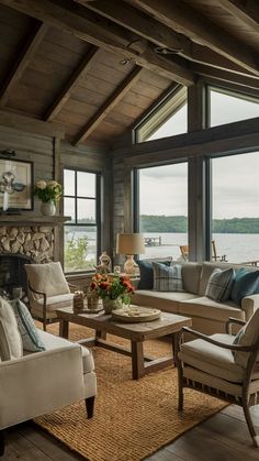 a living room filled with furniture and a fire place in front of a large window