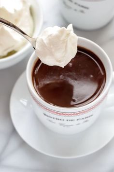 a spoon full of chocolate pudding and whipped cream