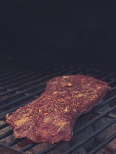 a piece of meat is cooking on the grill