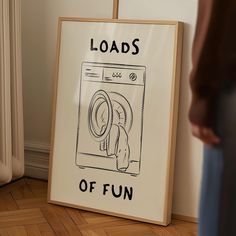 there is a sign that says loads of fun on the floor next to a washing machine