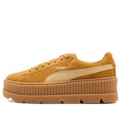 The Rihanna x Fenty Cleated Creeper 'Golden Brown' is the perfect mix of preppy and edgy. The monochromatic Golden Brown suede upper is accented by a padded collar and tonal leather Puma formstripe. The elevated Creeper platform midsole gives you some extra height, while the cleated rubber outsole provides traction and durability. Yellow Pngs, Puma X Fenty, Puma Fenty, Beige Sneakers, Suede Trainers, Suede Fashion, Rihanna Fenty, Puma X, Trending Sneakers