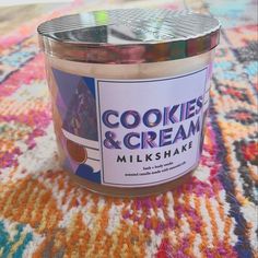 a jar of cookies and cream sits on a colorful rug