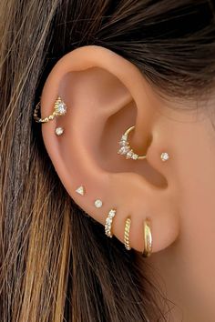 a woman's ear with three different types of piercings on the top and bottom