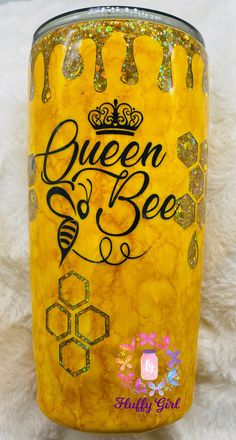 a yellow glass with the words queen bee on it