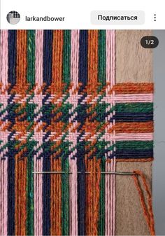 the weaving is being worked on by someone using yarn and needles to make it look like they