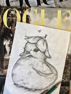 a pencil drawing of an animal on top of a magazine