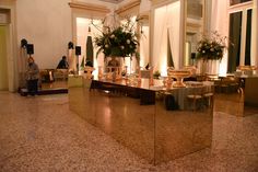 a large mirror in the middle of a room with flowers and candles on top of it