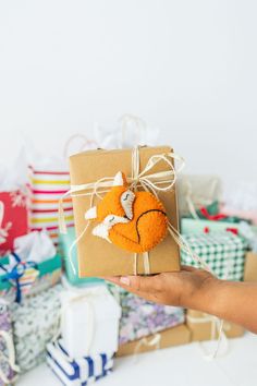 a person holding up a brown box with a fox decoration on it