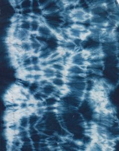 a blue tie - dyed shirt with black spots on it