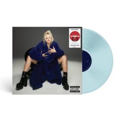 a blue vinyl album with a woman sitting on the floor wearing black boots and a fur coat