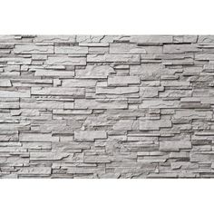 a stone wall that is white and grey