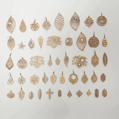 a collection of wooden earrings on display against a white background