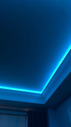 the ceiling is lit up with blue light and has a window in front of it