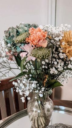 a vase filled with flowers sitting on top of a table