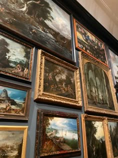 many paintings are hanging on the wall