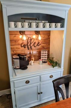 a blue hutch with lights and coffee on top