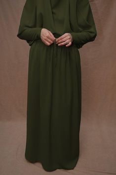 Introducing Army Green Moira Prayer Umrah Gown with Niqab Feature from Annah Hariri. This beautiful gown is made from high-quality Nada abaya fabric and features super light, stretchy jersey sleeves for ultimate comfort. The elasticated waistband and full skirt ensure a flattering and secure fit, while the khimar can be tied at the back of the head for added coverage.But the best part? This gown can also be transformed into a niqaab with just a few simple stitches. So whether you're performing U Modest Green Abaya For Eid, Green Long Sleeve Niqab For Eid, Green Niqab For Eid, Modest Green Maxi Length Abaya, Modest Green Maxi Dress For Eid, Abaya Fabric, Annah Hariri, Stylish Abaya, Modest Activewear