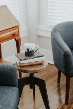 two chairs and a table with books on it