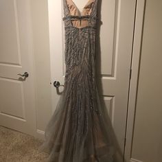 a dress hanging on the wall in front of a door