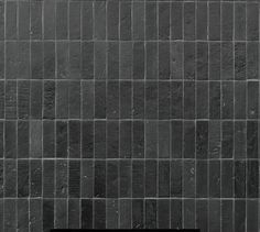 a black and white photo of a tile wall