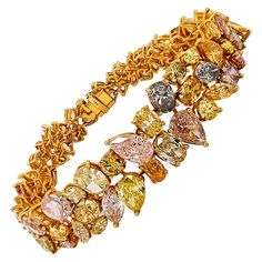 A stunning bracelet made in 18k yellow gold and is set with mixed cut fancy colored diamonds. Different range of hues from yellow, gray, blue, pink, purple, and orange. The 80 mixed-shape diamonds weigh a total of approximately 41.50 carats. Appraisal is available for potential buyers. The bracelet is 7.25 inches long. Luxury Diamond Multi-stone Bracelets, High Jewelry Bracelet, Vintage Diamond Necklace, Fine Jewlery, Colored Diamond Jewelry, Platinum Bracelet, Modern Bracelets, Emerald Bracelet, Yellow Jewelry