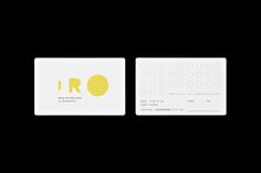 a white business card with yellow letters on the front and back side, against a black background