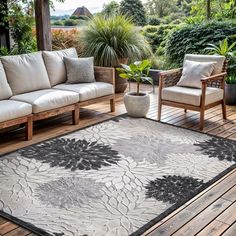 an outdoor area with couches, chairs and rugs on the wooden flooring