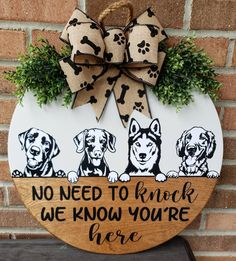 a wooden sign with three dogs on it that says, no need to knock we know you're here