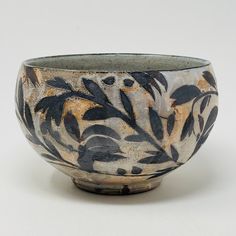 a black and white bowl sitting on top of a table