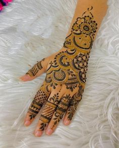 henna tattoo on the palm of a woman's hand