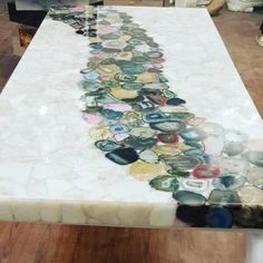 a long table covered in lots of different colored buttons