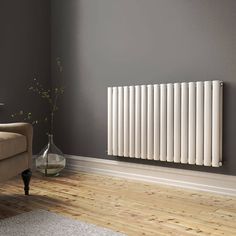 a living room with a couch, chair and radiator on the wall in front of it