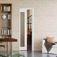 a living room with a couch, table and bookshelf next to a brick wall