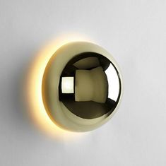 a light that is on the side of a wall with a circular object in it