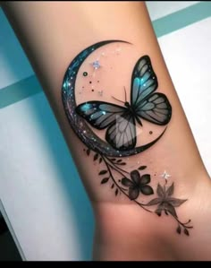 a tattoo with a butterfly on the side of it's leg and flowers around it