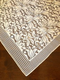 a white doily on top of a wooden table