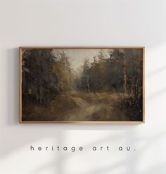 a painting hanging on the wall above a wooden frame