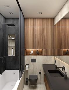 a modern bathroom with wood paneling and black counter tops, along with a white bathtub