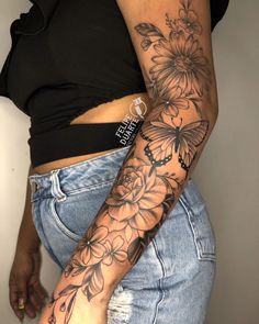 a woman's arm with flowers on it