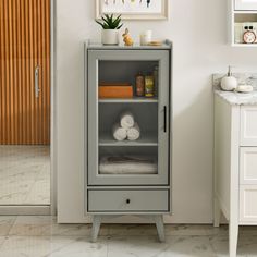 a cabinet with towels and candles in it