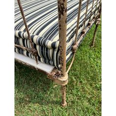 an old metal bed frame with striped fabric