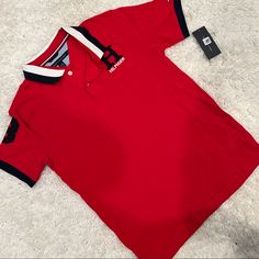 Tommy Hilfiger Red Polo Shirt Red Polo Collar T-shirt For Summer, Casual Red Tommy Hilfiger T-shirt, Red Collared Sporty Shirt, Red Sporty Polo Collar Top, Sporty Red Polo Collar Top, Sporty Red Short Sleeve Polo Shirt, Sporty Red Top With Polo Collar, Sporty Red Collared T-shirt, Tommy Hilfiger Red Short Sleeve Top