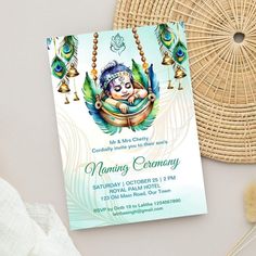 a birthday card with an image of a baby in a hammock and peacock feathers