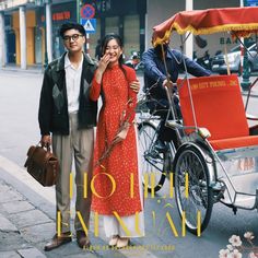 two people standing next to each other in front of a horse drawn carriage on the street